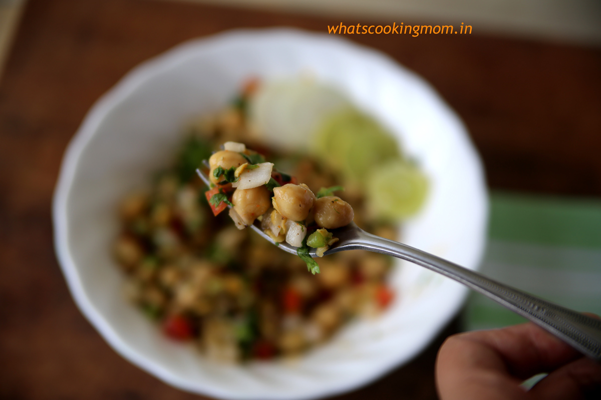 Chana chaat scooped up in a fork