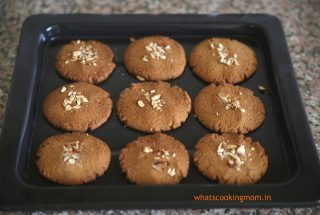 9 baked almond Cookies on a baking tray
