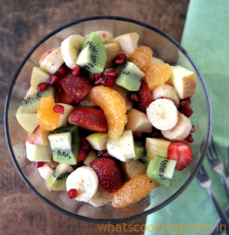 Winter Fruits Salad in a glass bowl on a wooden table