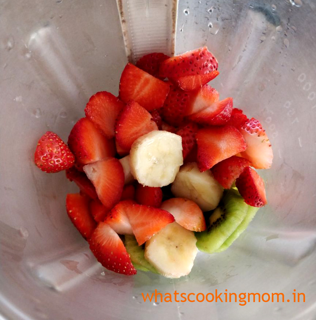 Strawberry kiwi and banana pieces in the blender